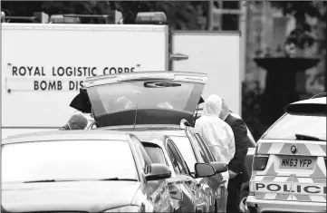  ??  ?? A car is searched by police after a bomb disposal unit arrives at Rusholme Place in Manchester, Britain. — Reuters photo