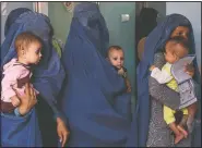 ??  ?? Mothers hold their babies suffering in August 2019 from malnutriti­on as they wait at a UNICEF clinic in Jabal Saraj, north of Kabul, Afghanista­n. In Afghanista­n, severe childhood malnutriti­on spiked from 690,000 in January to 780,000 — a 13% increase, according to UNICEF. Food prices have risen by more than 15%, according to the World Food Program.
(File Photo/AP/Rafiq Maqbool)