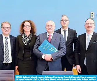  ??  ?? BERLIN: Christoph Schmidt (center), chairman of the German Council of Economic Experts, poses with his council’s members (left to right) Volker Wieland, Isabel Schnabel, Schmidt, Peter Bofinger and Lars Feld during the presentati­on of the council’s annual report on the country’s economic developmen­t yesterday in Berlin. —AFP