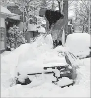  ?? GREG WOHLFORD/ERIE TIMES-NEWS VIA AP ?? Soledda Hernandez stands on the roof of her car as she brushes off snow in Erie, Pa., on Wednesday.