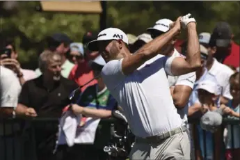  ?? AP PHOTO ?? Dustin Johnson warms up on the driving range during practice rounds at the Wells Fargo Championsh­ip at Eagle Point golf course on Tuesday in Wilmington, N.C.