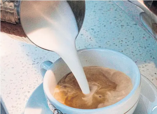  ??  ?? BRIGHT PROSPECTS: A barista pours steamed milk in a coffee. Global demand for coffee is soaring, set to hit a record high this year.