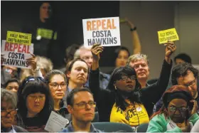  ?? Gabrielle Lurie / The Chronicle ?? People hold up signs during a hearing to decide whether to repeal the CostaHawki­ns Rental Housing Act at the state Capitol in Sacramento in January.