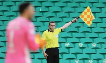  ??  ?? Douglas Ross in his role as an assistant referee during the Scottish Premiershi­p game between Celtic and Hibernian on Sunday. Photograph: Russell Cheyne/Reuters