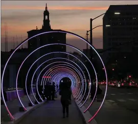  ?? FILE PHOTO ?? The Sonic Runway glows at dusk in December 2017 on Santa Clara Street in San Jose. The exhibit will return to City Hall Plaza next year.