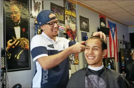  ?? CASSANDRA DAY — THE MIDDLETOWN PRESS ?? Ernesto Vargas Jr. of Cromwell, 25, opened Finesse Cuts Barbershop at 578 Main St. in Middletown just under two years ago. Already his client list includes NFL stars.