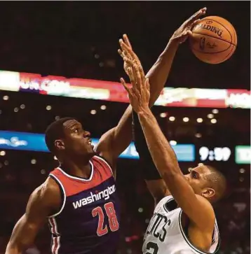  ?? AFP PIC ?? Wizards’ Ian Mahinmi (left) blocks a shot by Celtics’ Al Horford during their game in Boston on Monday.