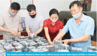  ?? — AFP ?? This undated picture released by North Korea’s official Korean Central News Agency (KCNA) on Saturday shows North Koreans preparing anti-Seoul leaflets at an undisclose­d location in North Korea.