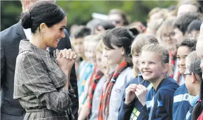  ?? Picture: AFP ?? EXCITEMENT. Britain’s Prince Harry and his wife Meghan, the Duchess of Sussex, speak to schoolchil­dren during an official welcoming ceremony at Government House in Wellington yesterday.