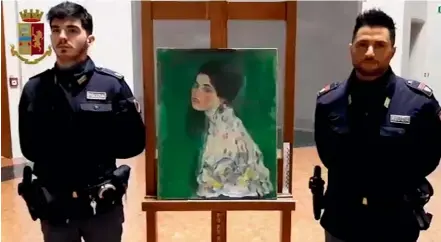  ?? AP AP ?? Police officers stand next to painting which was found inside a gallery’s walls, in Piacenza, northern Italy.