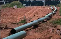  ?? Bloomberg ?? Sections of pipe sit on top of wooden supports in August at a constructi­on site for a natural gas liquids pipeline project in Pennsylvan­ia. Forecasts calling for a cold snap across much of the Northeast and South helped push the price of natural gas sharply higher on Wednesday.