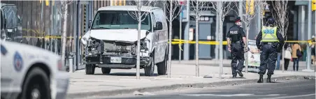  ??  ?? The rental van used in Monday’s deadly rampage sits on a sidewalk in Toronto’s North York district.