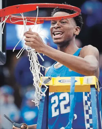  ?? JEFF ROBERSON THE ASSOCIATED PRESS ?? Hamilton native Shai Gilgeous-Alexander cuts down the net after Kentucky defeated Tennessee in the championsh­ip game at the Southeaste­rn Conference tournament Sunday.