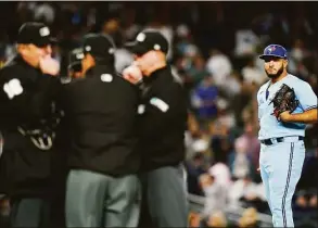  ?? Frank Franklin II / Associated Press ?? Toronto Blue Jays relief pitcher Yimi Garcia watches as home plate umpire Lance Barrett, left, talks with other upmires after Garcia hit New York Yankees’ Josh Donaldson with a pitch during the sixth inning on Tuesday in New York.