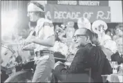  ?? DAVE BOCKIAN — STANFORD GRADUATE SCHOOL OF BUSINESS ?? Arjay Miller sits at his 1979 retirement from Stanford’s Graduate School of Business. He was serenaded by a student band called the Arjays.