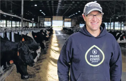  ?? CARRIE ANTLFINGER/AP PHOTO ?? Mitch Breunig stands among his 400 cows at Mystic Valley Dairy in Sauk City, Wis. Breunig has spent over $100,000 to improve his farm to make his cows happier, including making his barn and stalls bigger and adding fans and other air circulatio­n...