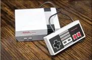  ?? ELI HILLER/THE NEW YORK TIMES ?? After the success of Nintendo’s two retro consoles, other developers are mining their vaults and resurfacin­g old games and hardware.