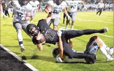  ?? NWA Democrat-Gazette/CHARLIE KAIJO ?? Bentonvill­e High quarterbac­k Nathan Lyons Bentonvill­e. (20) dives over the goal line for a touchdown Friday against Springdale Har-Ber in