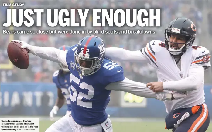  ?? AL BELLO/GETTY IMAGES ?? Giants linebacker Alec Ogletree escapes Chase Daniel’s attempt at tackling him on his pick-six in the first quarter Sunday.