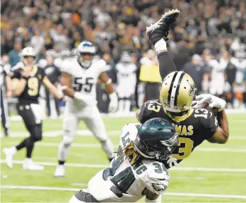  ?? BILL FEIG/AP ?? Saints wide receiver Michael Thomas (13) pulls in a touchdown reception against Eagles cornerback Cre'von LeBlanc in the second half of Sunday's game.