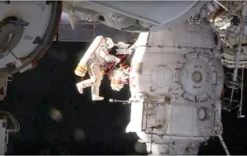  ??  ?? Russian cosmonaut Oleg Kononenko conducts a spacewalk outside the Internatio­nal Space Station Space in this still image captured from Nasa video in space. — Reuters photo