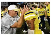  ?? DANIEL VARNADO / AP ?? Georgia Tech interim head coach Brent Key celebrates with defensive back Clayton Powell-Lee (right) after defeating Duke 2320 in overtime on Saturday in Atlanta.