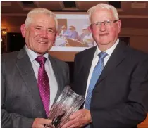  ??  ?? Enda O’Connor, BOM, makes presentati­on to founder member, Tony Woulfe, at the Gorey Credit Union 50th anniversar­y dinner in the Ashdown Park Hotel.