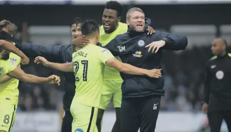  ??  ?? Posh manager Grant McCann celebrates with Tom Nichols after the striker’s last-minute winning goal at Bristol Rovers last season.