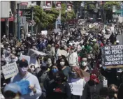  ?? JEFF CHIU— ASSOCIATED PRESS ?? People march on Ocean Avenue in San Francisco, Sunday, June 7, 2020, during a protest over the death of George Floyd, who died May 25 after being restrained by police in Minneapoli­s.
