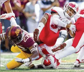  ?? HANNAH FOSLIEN / GETTY IMAGES ?? Miami University kick returner Maurice Thomas, an Oxford Talawanda grad, is brought down by Jordan Howden of the Minnesota Golden Gophers (left) during the opening kickoff in a game at TCF Bank Stadium in Minneapoli­s.