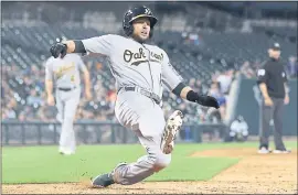  ?? CARLOS OSORIO — THE ASSOCIATED PRESS ?? The Athletics’ Jed Lowrie scores from second on a single by Dustin Fowler in the ninth.