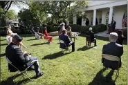  ?? ALEX BRANDON - THE ASSOCIATED PRESS ?? President Donald Trump listens as Sister Eneyda Martinez, with Poor Sisters of St. Joseph, at left podium, speaks during a White House National Day of Prayer Service in the Rose Garden of the White House, Thursday, May 7, in Washington.