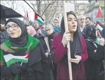  ?? AP photo ?? Demonstrat­ors hold Palestinia­n flags as they stage a protest in Paris, France, against U.S. President Donald Trump’s decision to recognize Jerusalem as the capital of Israel. An estimated 400 protestors gathered Sunday in the rally called by...