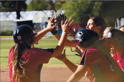  ?? PHOTOS COURTESY OF TRETT BISHOP ?? Lilianna Cruz (left) is congratula­ted by teammates after hitting a three-run homer in Clear Lake’s 16-1 league win on Friday in Kelseyvill­e. Cruz also was the winning pitcher.