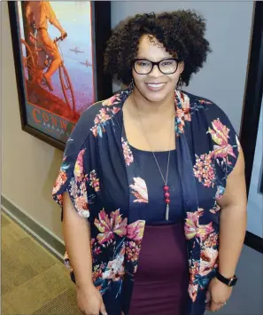  ?? TAMMY KEITH/RIVER VALLEY & OZARK EDITION ?? Adena White stands in the hallway of the Conway Area Chamber of Commerce. White, 34, is director of communicat­ions for the chamber. She also writes a blog, available at blackbeltv­oices.com. White was inducted in January as the first black president of the Arkansas chapter of the Public Relations Society of America in its 55-year history. The woman who nominated her compliment­ed White’s writing skills and said it was “about time” for a black president.