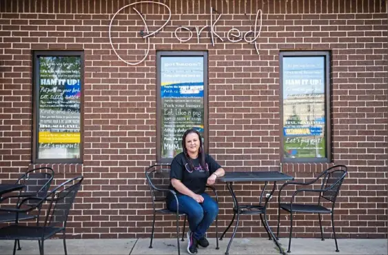  ?? Michael M. Santiago/Post-Gazette ?? Natalie Bobak, owner of Porked Lincoln Place, sits at her restaurant in Lincoln Place. Because of high interest loans and fees, Ms. Bobak was forced to file for bankruptcy, which has given her some breathing room in getting her finances in order again.