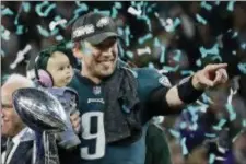  ?? THE ASSOCIATED PRESS ?? Eagles’ Nick Foles holds his daughter, Lily, after beating the New England Patriots in the Super Bowl 52 on in Minneapoli­s.