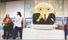  ?? REBECCA S. GRATZ/AP ?? THE SQUISHMALL­OWS BOOTH sells toys modeled after Warren Buffett, pictured, and Charlie Munger in the exhibit hall for the Berkshire Hathaway annual meeting on May 6, 2023 in Omaha, Neb.