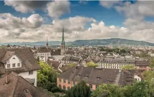  ??  ?? This page, from top: views over the city; Zunfthaus zur Waag guild house; its head chef Alan Koenig. Opposite page, clockwise from top left: floodlit Grossmünst­er church; minimalist design at 25hours Hotel; mountains loom behind Zurich; poached trout...