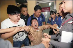  ?? PICTURE: RUNGROJ YONGRIT / EPA ?? HORROR: Chinese man Gao Yan Ping cries out in grief as he is helped by relatives and police after he had identified the bodies of his wife Huang Yu Lan and daughter Gao Yu Zhu, both killed in Monday’s Erawan shrine bomb blast in Bangkok.