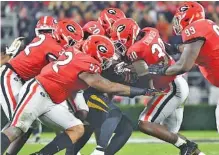  ?? GEORGIA PHOTO BY PERRY MCINTYRE ?? Georgia defenders Monty Rice, left, Tyler Clark (52), J.R. Reed (20), Tae Crowder (30) and Jordan Davis (99) swarm to the ball during last Saturday’s 27-0 home win against Missouri.