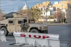  ?? Nathan Howard/Getty Images ?? A National Guardsman monitors a security checkpoint near the U.S. Capitol on Tuesday.