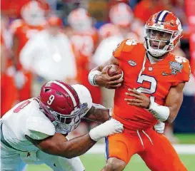  ?? [AP PHOTO] ?? Clemson quarterbac­k Kelly Bryant, right is sacked by Alabama lineman Da’Shawn Hand during the Sugar Bowl in January. Bryant led the Tigers to a 12-2 record last season, but he isn’t guaranteed of winning the starting job this fall.