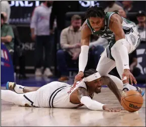  ?? GREGORY SHAMUS — GETTY IMAGES ?? Denver’s Kentavious Caldwell- Pope dives for the ball past Detroit’s Jaden Ivey on Thursday. Caldwell- Pope was honest about last week’s meeting. “It’s not the time to be losing games that we’re supposed to be winning.”