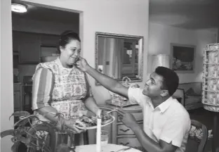  ??  ?? Right: The then Cassius Clay pictured at home in Louisville, Kentucky, with his mother Odessa Grady Clay, who is serving him fried chicken