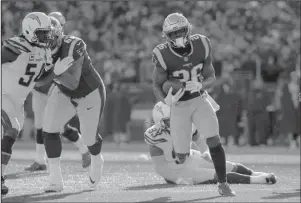  ?? The Associated Press ?? BRAND NAME: New England running back Sony Michel, right, heads for the goal line and his second touchdown Sunday during the first half of the Patriots’ 41-28 win against the Los Angeles Chargers in the divisional round of the NFL playoffs in Foxborough, Mass.