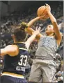  ?? Jessica Hill / Associated Press ?? UConn’s Napheesa Collier shoots over Notre Dame’s Kathryn Westbeld during the first half of a game on Dec. 3, 2017, in Hartford.