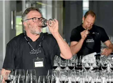  ??  ?? Australian judge Ralph Kyte-Powell tastes a line-up of pinot noir at the Air New Zealand Wine Awards judging in Auckland.