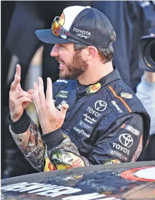  ?? THE ASSOCIATED PRESS ?? Martin Truex Jr. gestures as he celebrates his seventh NASCAR Cup Series race win of the season at Kansas Speedway on Sunday in Kansas City, Kan.