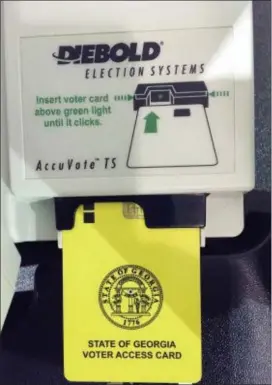  ?? THE ASSOCIATED PRESS ?? This photo shows a voter access card inserted in a voting reader during voting in the Georgia primary in Kennesaw, Ga.